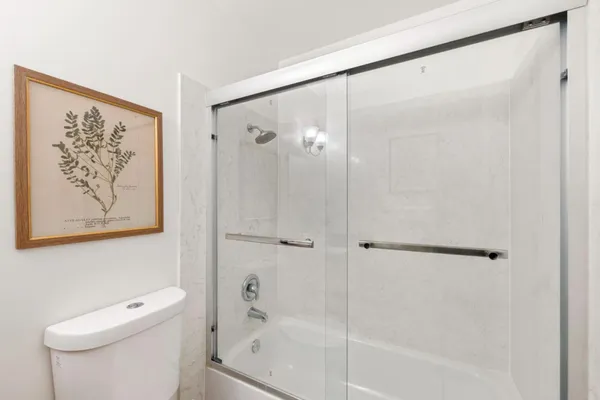 a bathroom with a shower and a toilet
