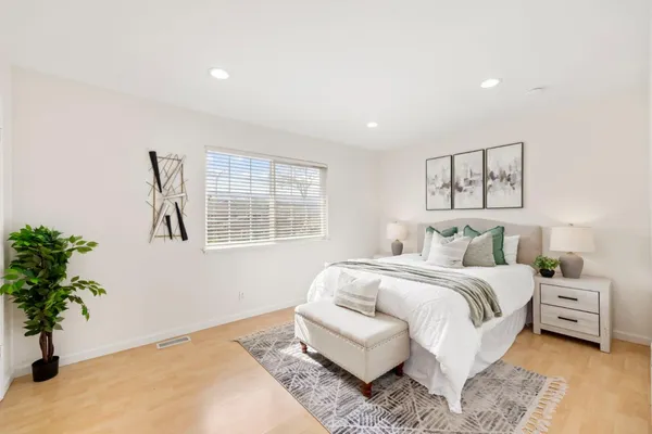 a bedroom with a bed and a window