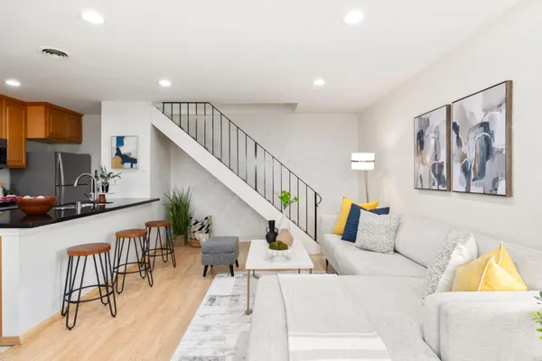 a living room with furniture and wooden floor