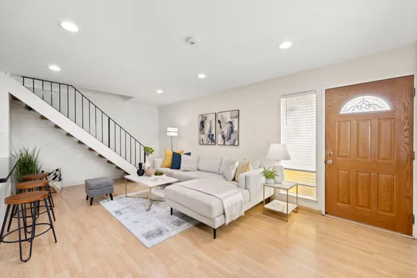 a living room with furniture and wooden floor
