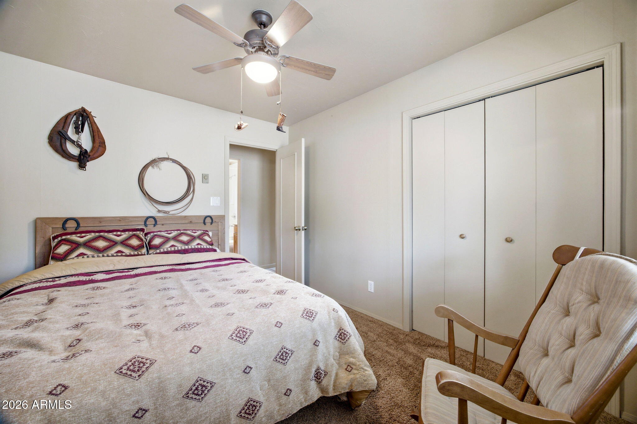 3072 Chevelon Road Overgaard, AZ 85933 - Photo 13 of 51 a bedroom with a bed and a chandelier