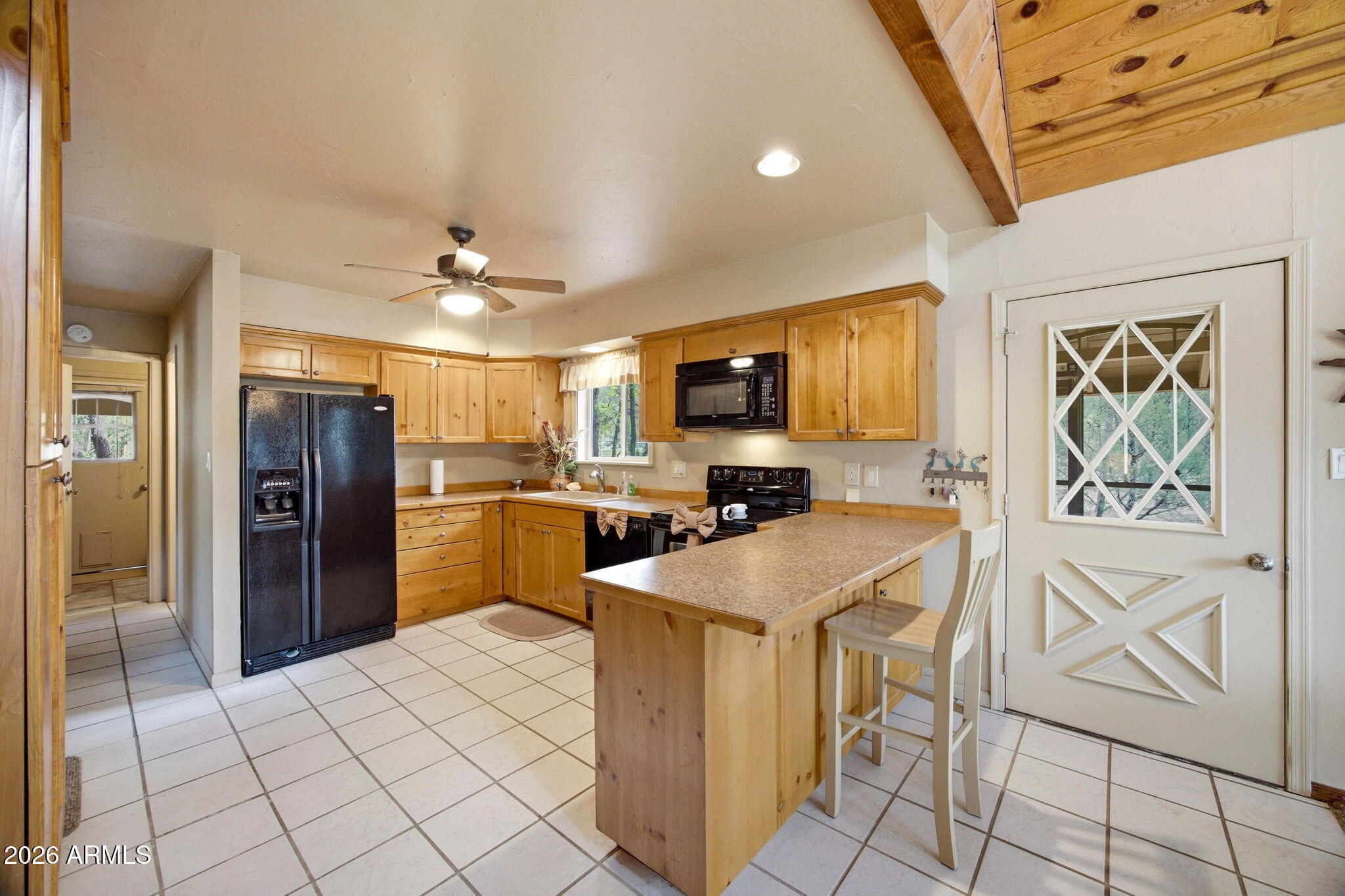 3072 Chevelon Road Overgaard, AZ 85933 - Photo 4 of 51 a kitchen with stainless steel appliances a refrigerator and microwave