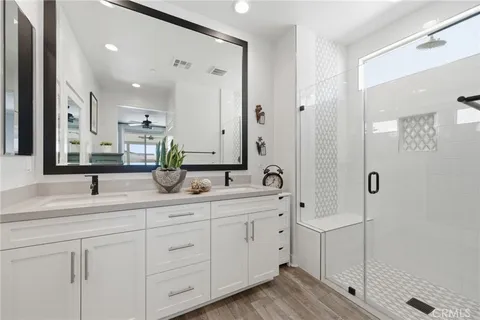 a bathroom with a double vanity sink and mirror