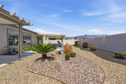 a view of a house with backyard porch and sitting area
