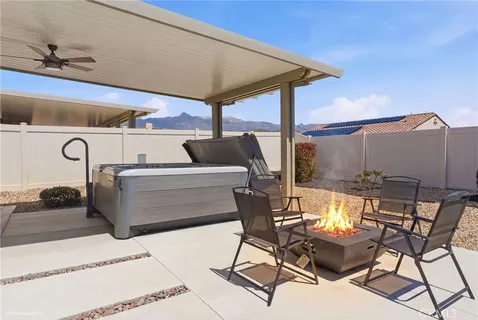 a view of a patio with a table and chairs under an umbrella