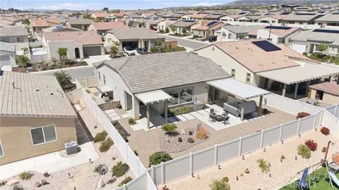 an aerial view of a house with wooden deck