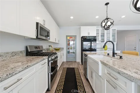 a kitchen with stainless steel appliances granite countertop a stove and cabinets