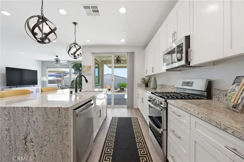 a kitchen with stainless steel appliances granite countertop a sink and stove