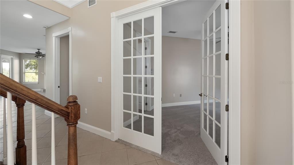 10651 Arrowtree Boulevard Clermont, FL 34715 - Photo 13 of 51 a view of a hallway with windows and entryway