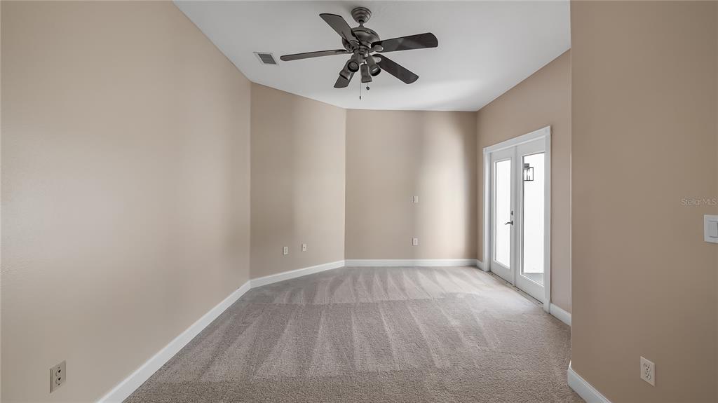 10651 Arrowtree Boulevard Clermont, FL 34715 - Photo 14 of 51 a view of a room with a ceiling fan and a window