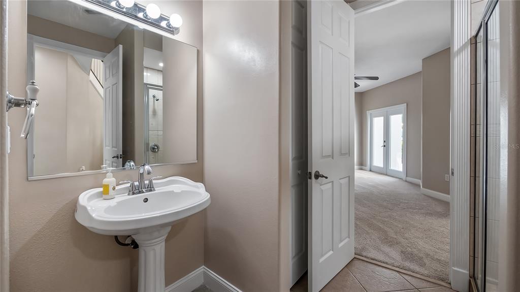 10651 Arrowtree Boulevard Clermont, FL 34715 - Photo 15 of 51 a bathroom with a sink and a mirror