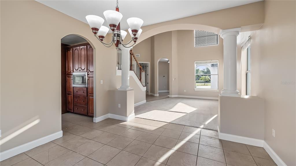10651 Arrowtree Boulevard Clermont, FL 34715 - Photo 16 of 51 a view of a hallway with chandelier and front door
