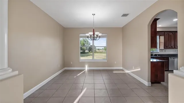 a kitchen with stainless steel appliances granite countertop wooden cabinets a stove top oven a sink and dishwasher