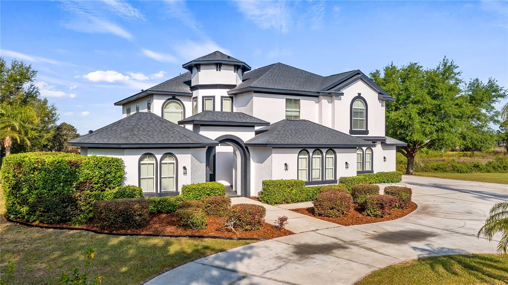 10651 Arrowtree Boulevard Clermont, FL 34715 - Photo 2 of 51 a front view of a house with a garden