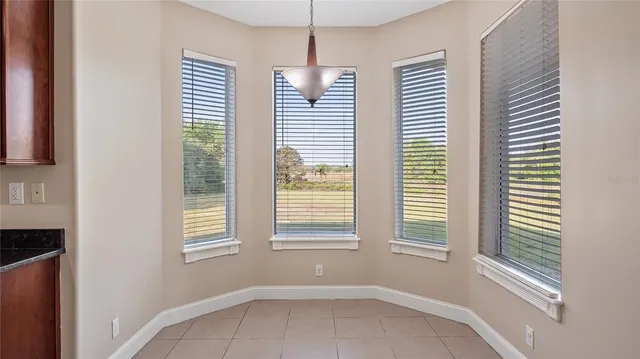 a view of an empty room with a fireplace and a window