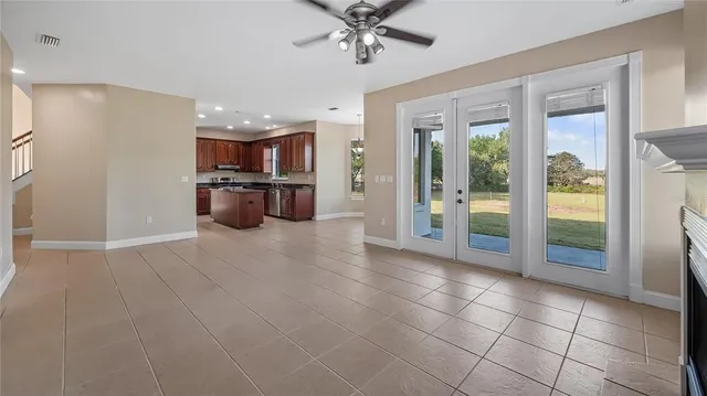 a view of a hallway with wooden floor and a living room