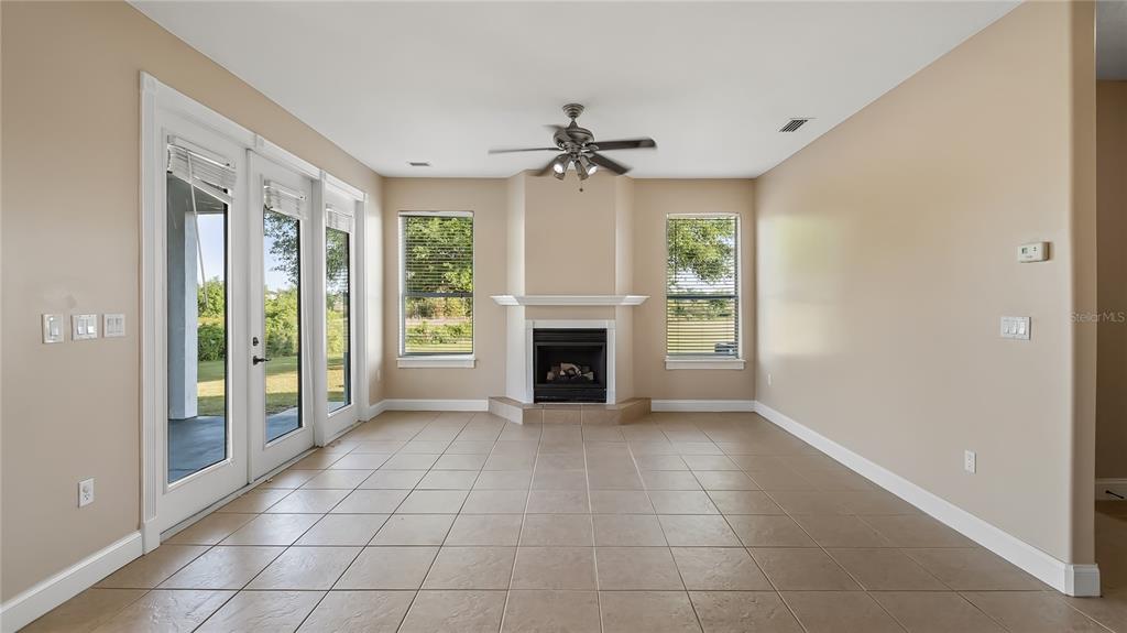 10651 Arrowtree Boulevard Clermont, FL 34715 - Photo 23 of 51 a view of an empty room with a fireplace and a window