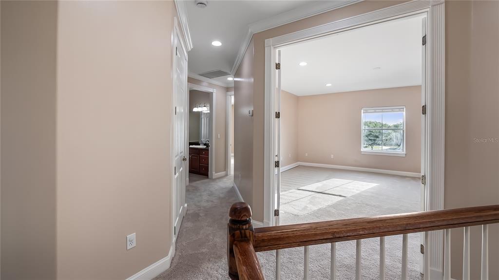 10651 Arrowtree Boulevard Clermont, FL 34715 - Photo 24 of 51 a view of a hallway with wooden floor and a living room