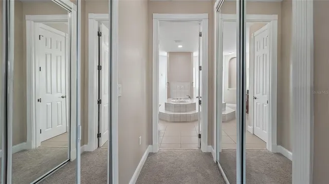 a bathroom with a tub sink and mirror