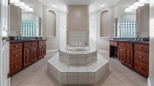 a bathroom with a tub sink and mirror