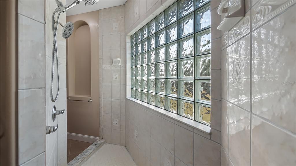 10651 Arrowtree Boulevard Clermont, FL 34715 - Photo 33 of 51 a bathroom with a bathtub and a shower