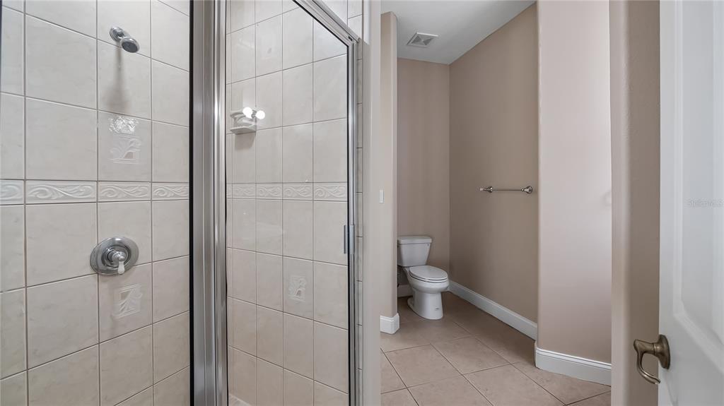 10651 Arrowtree Boulevard Clermont, FL 34715 - Photo 38 of 51 a bathroom with a toilet and a shower