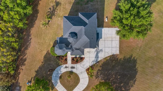 a backyard of a house with fountain table and chairs