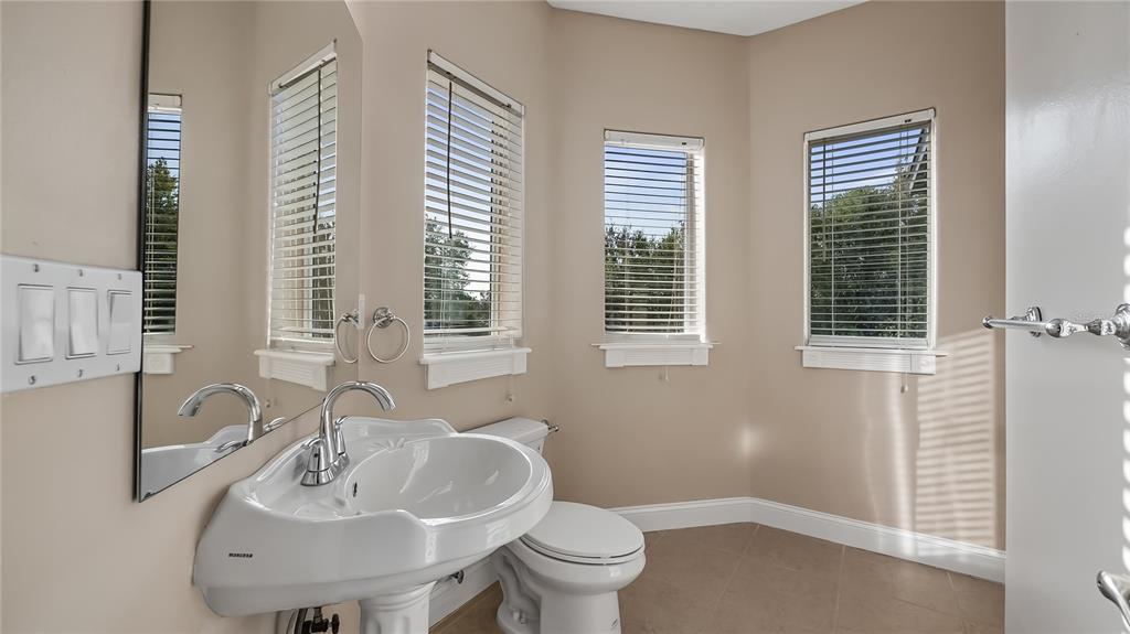 10651 Arrowtree Boulevard Clermont, FL 34715 - Photo 41 of 51 a bathroom with a sink and a toilet