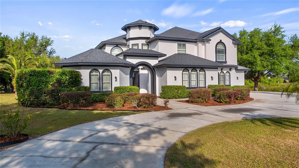 10651 Arrowtree Boulevard Clermont, FL 34715 - Photo 51 of 51 a front view of a house with a garden