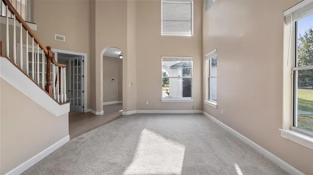 a view of a hallway with wooden floor and stairs