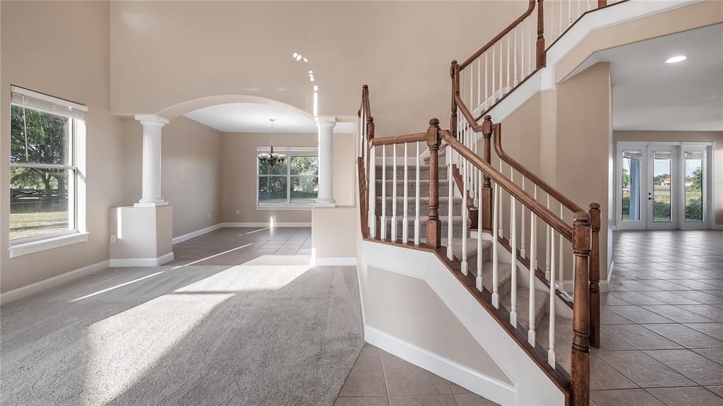 10651 Arrowtree Boulevard Clermont, FL 34715 - Photo 8 of 51 a view of a hallway with wooden floor and stairs