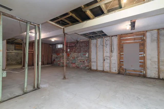 a view of empty room with wooden walls