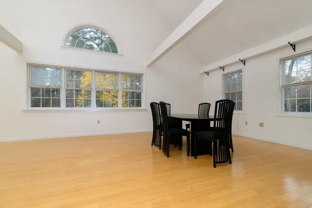 a view of a dining room with furniture and chandelier