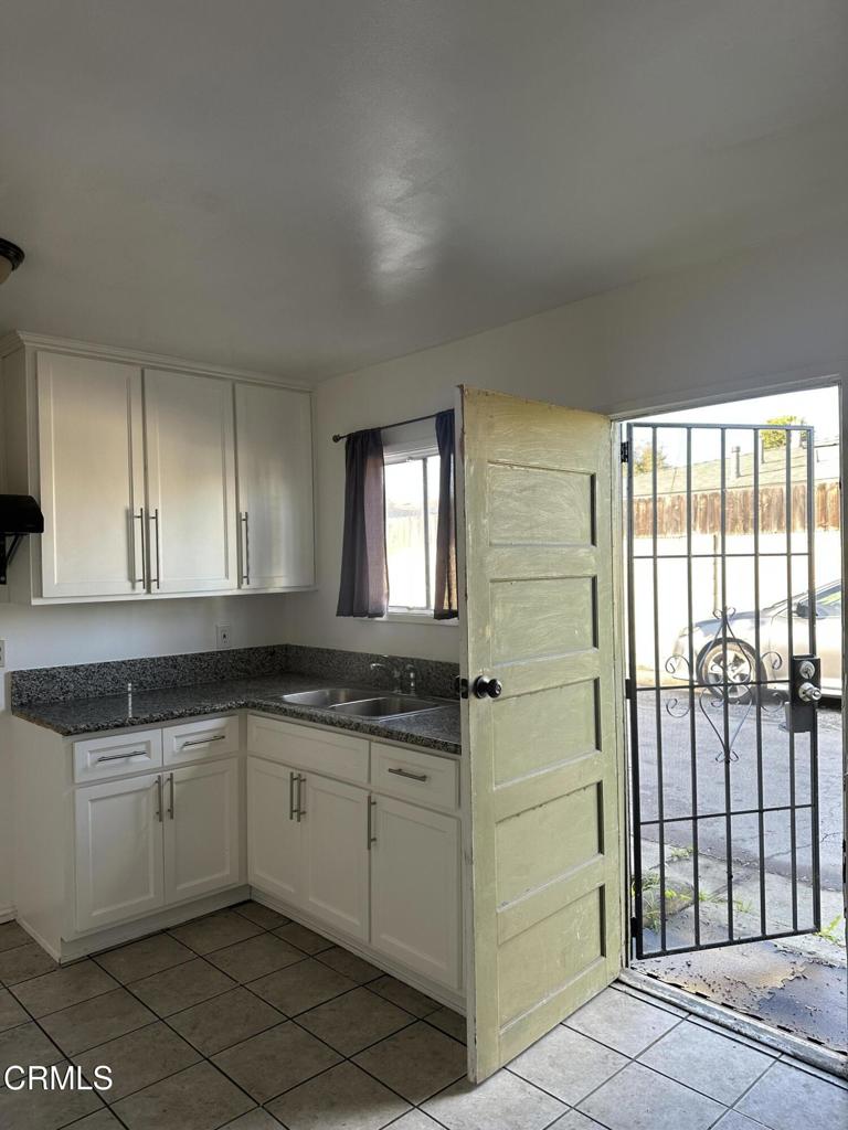 17002 Downey Avenue, Unit 17000 Paramount, CA 90723 - Photo 9 of 16 a kitchen with a sink cabinets and window