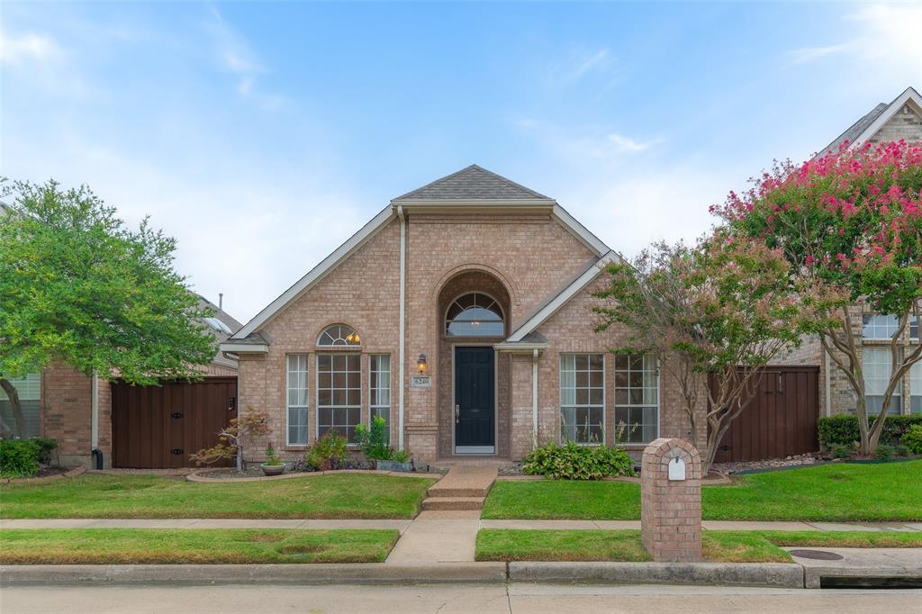 a front view of a house with a garden and plants