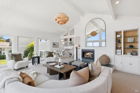 a view of a dining room with furniture a chandelier and wooden floor