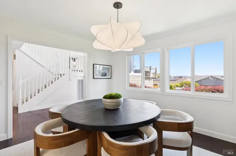 a view of a sink a mirror and a potted plant in a kitchen