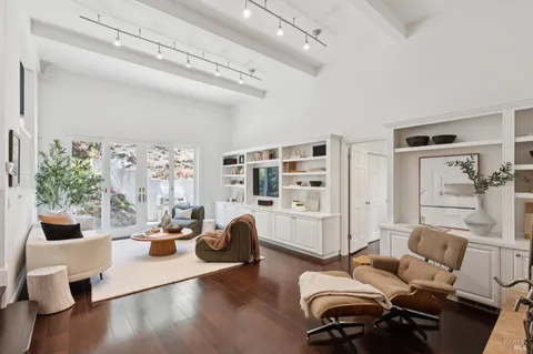 a living room with furniture a table and a large window