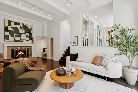 a bedroom with a bed and a potted plant
