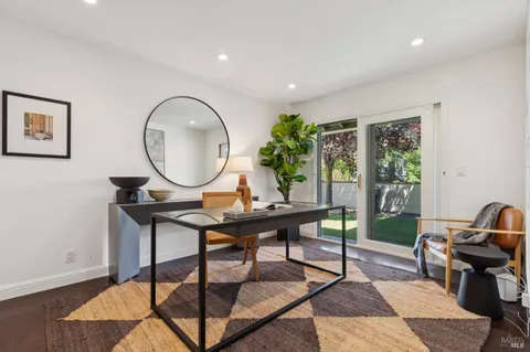 a bedroom with a bed and a flat tv screen on dresser