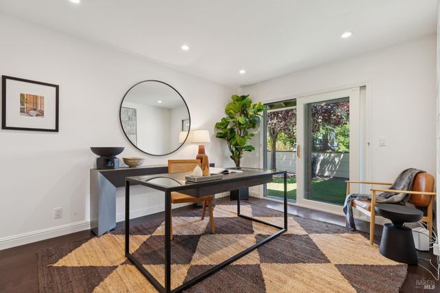 a bedroom with a bed and a flat tv screen on dresser