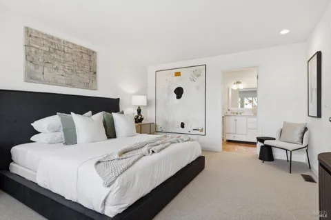 a backyard of a house with wooden fence and a bench