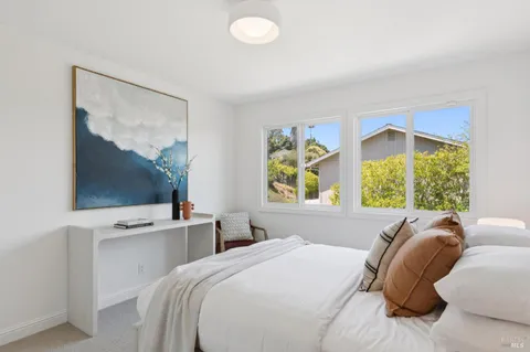a aerial view of a house with a yard and lake view