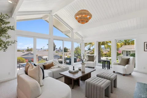 a living room with furniture a fireplace and a potted plant