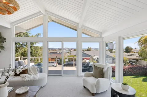 a living room with furniture a fireplace and a potted plant