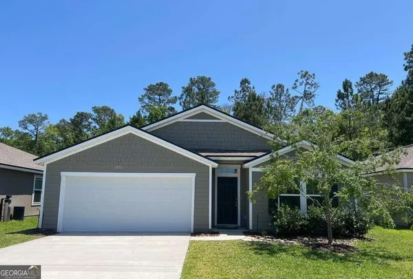a front view of a house with a yard garage and outdoor seating