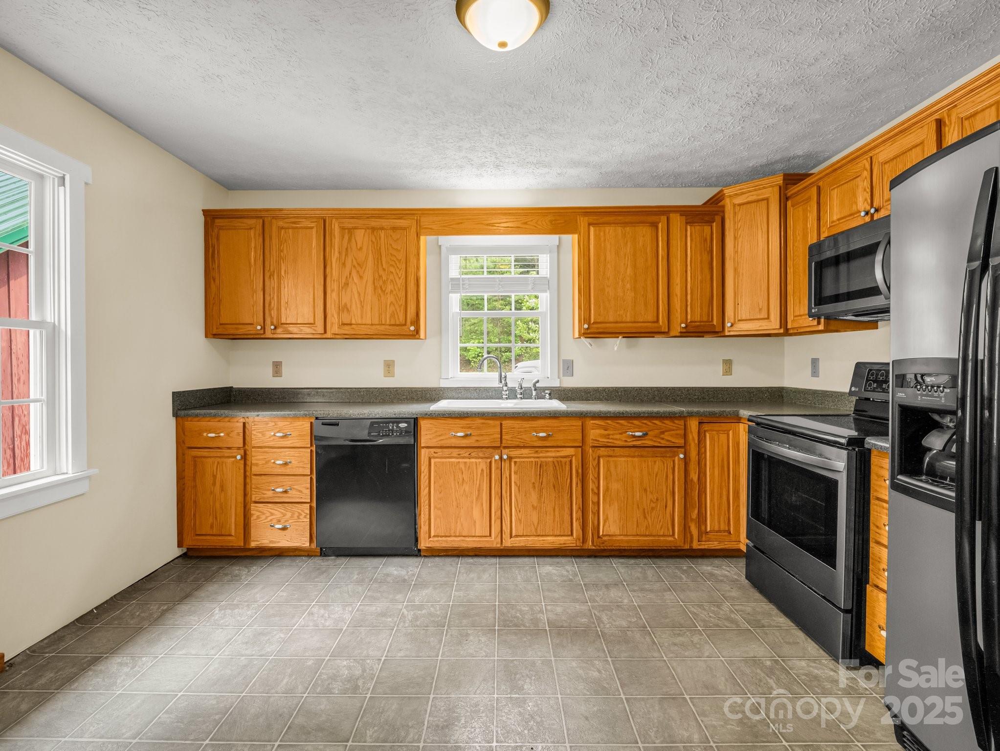 4086 Big Island Road Rutherfordton, NC 28139 - Photo 12 of 47 a kitchen with stainless steel appliances granite countertop a stove a sink and a microwave