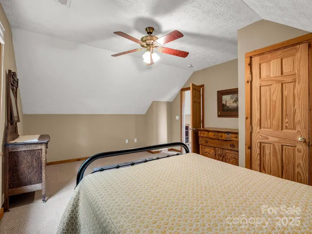 a bedroom with a bed next to a window