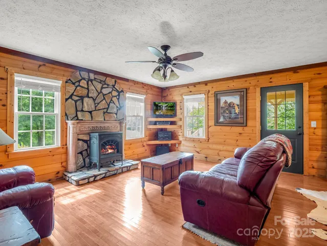 a living room with furniture a ceiling fan and a rug