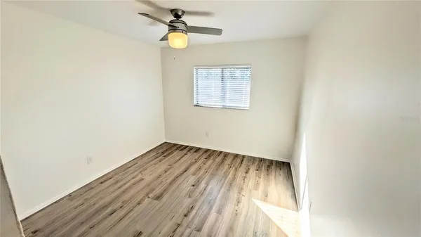 a view of hallway with wooden floor
